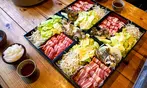 All You Can Eat BBQ & Sushi Extravaganza: Savory Meats, Rolls & More!