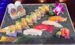All You Can Eat BBQ & Sushi Extravaganza: Savory Meats, Rolls & More!