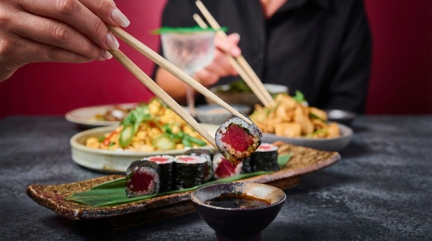 A vibrant spread of various sushi rolls and nigiri with refreshing beverages, presented beautifully in the lively setting of Soul Street.