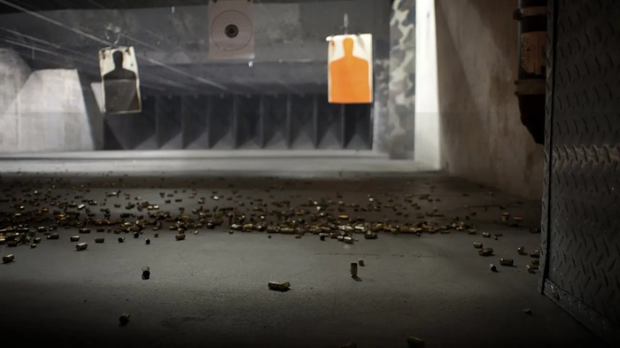 Frisco Gun Club indoor shooting range with safety bays and ambient lighting