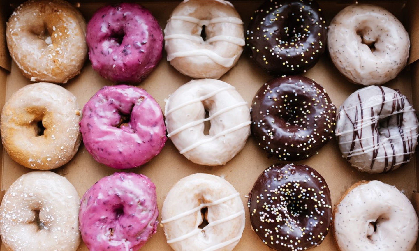 Up to a Dozen Donuts, 4 Donuts & 2 Drinks or $50 to Spend