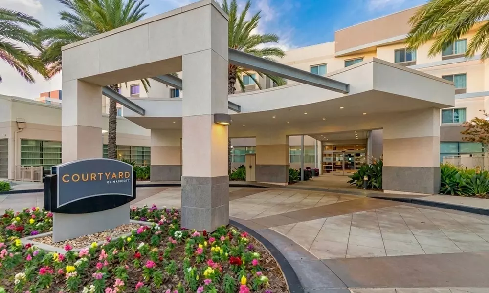 Courtyard-Style Hotel Retreat with Outdoor Pool & Bistro Dining