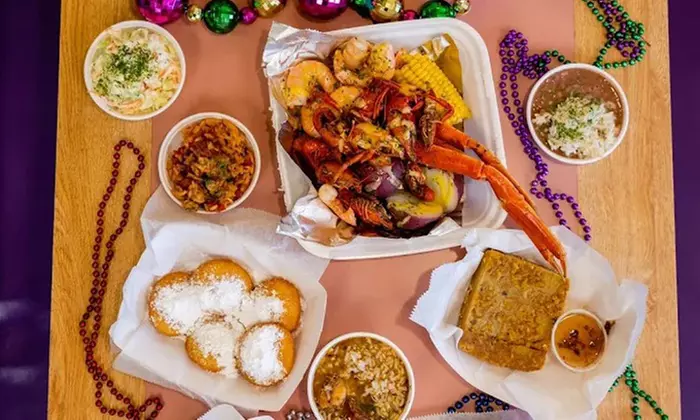 Two Po'Boys, Meals for Two or Four With Beignets, and $50–$75 Credits