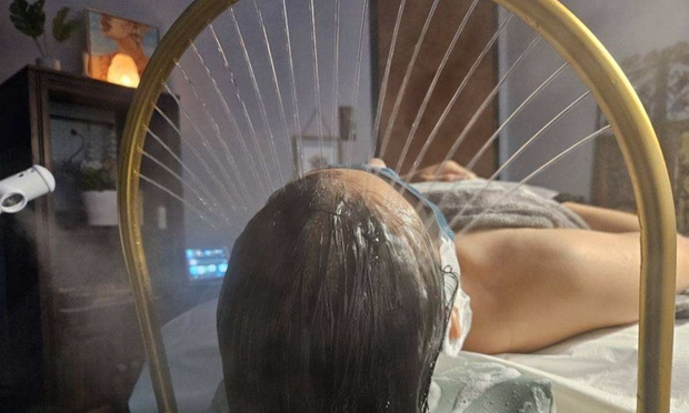 Person receiving a relaxing head spa treatment with steam