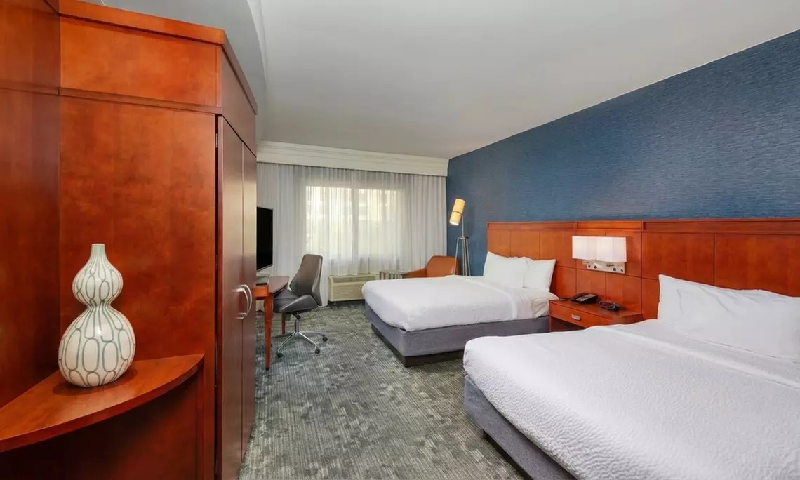 Courtyard-Style Hotel Retreat with Outdoor Pool & Bistro Dining