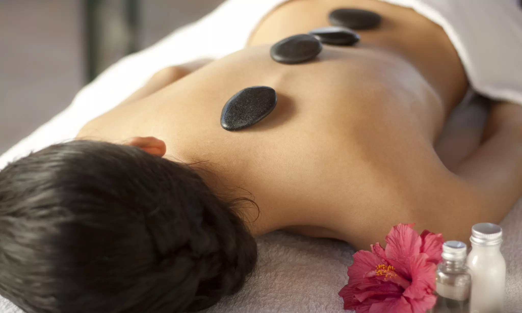 30 or 60-Minute Swedish or Deep-Tissue Massage with Hot Stone Bamboo or Himalayan Salt (Up To 60% Off) - Primary Image