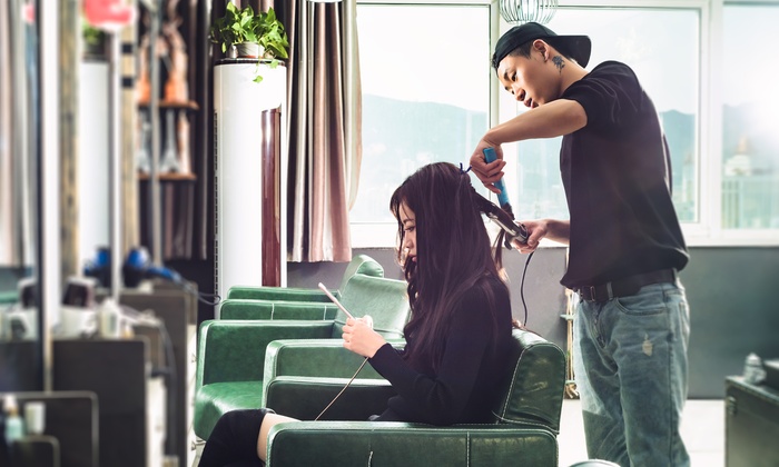 A customer receiving a professional blow-dry after a wash and cut at a salon.