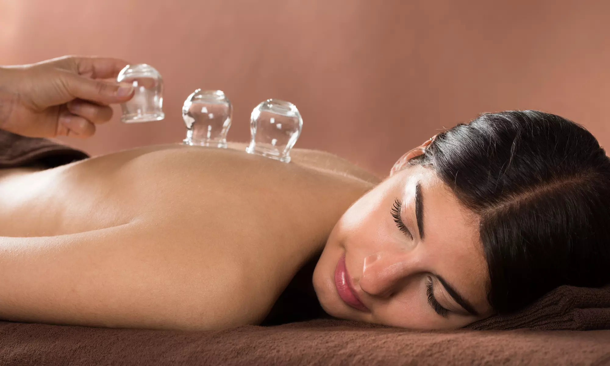 Relax with Cupping, Infrared, Volcanic Hot Stone Massage Sessions w/Add-ons at Hngh Health Spa (Up to 63% Off) - Primary Image