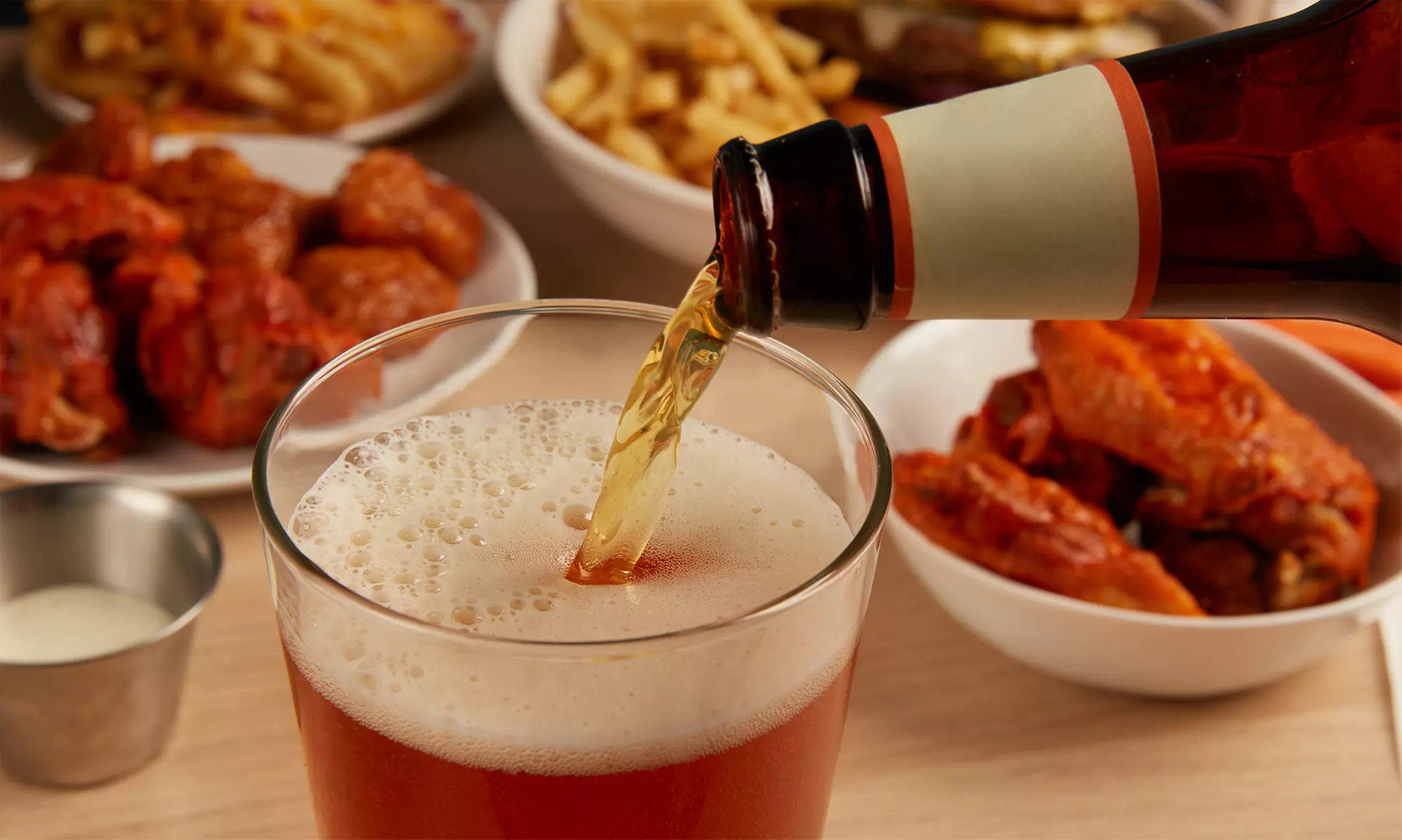 Chill & Thrill: Grab a Bucket of 5 Domestic Beers w/ Optional 6 Wings at Paulie's Pub & Grille ( Up to 37% Off ) - Primary Image
