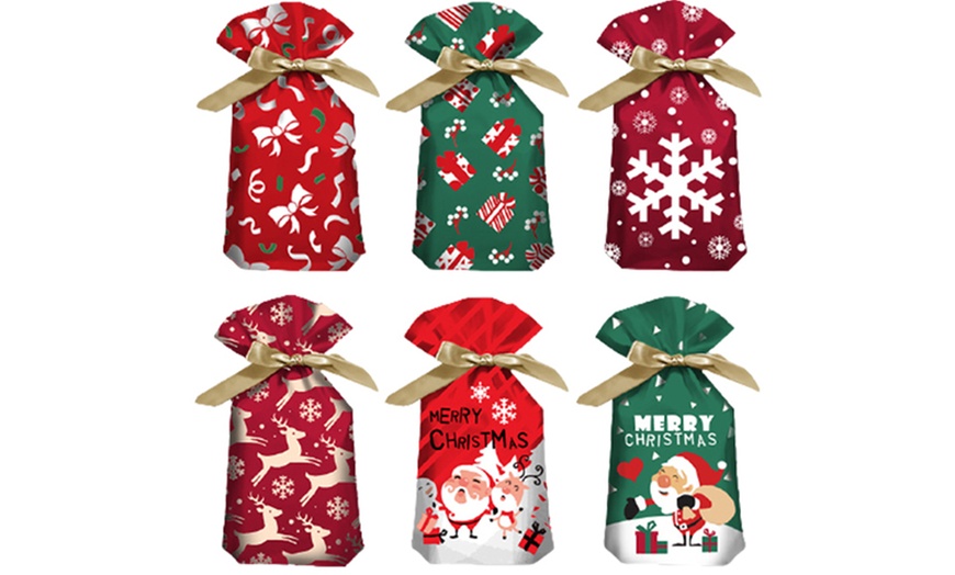 Image 1: 50-Piece Christmas Drawstring Gift Bag Set