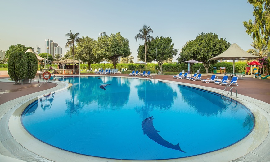 Image 1: Light snacks and refreshing beverage all day by the pool 