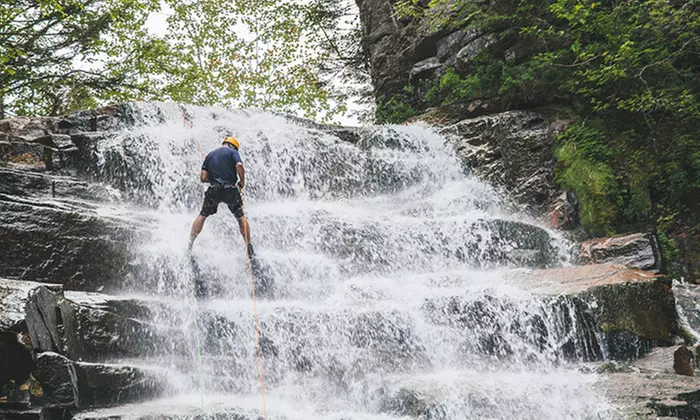 Join Northeast Mountaineering's thrilling rappelling adventures at Ripley Falls, with solo, duo, and group options up to 20% off - Second Medium