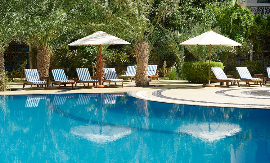 Image 1: Pool and drinks at Le Royal Meridien