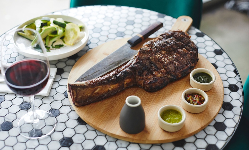 Image 2: Tomahawk steak, sides, and wine