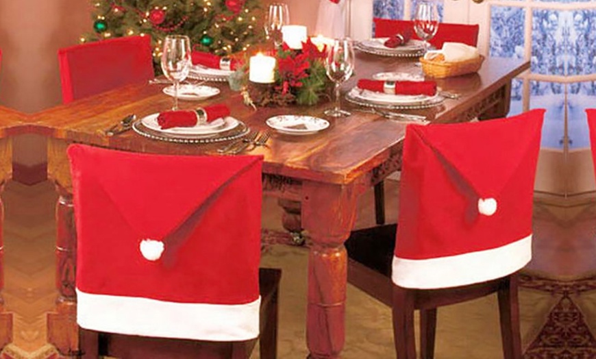 Image 1: Santa Hat Dining Chair Covers
