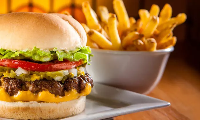 One or Two Original Fatburgers with Cheddar and Skin-On Fries at Fatburger (Up to 38% Off) - Primary Image
