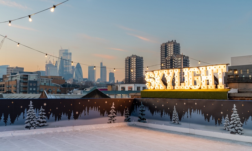 Image 1: Rooftop Ice Skating with meal, Raclette or Cocktails