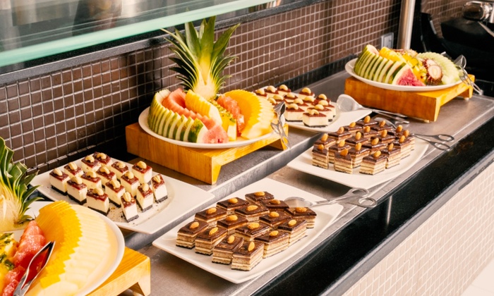 A lavish Iftar buffet spread with international and local dishes, including mixed grill, salads, and desserts.