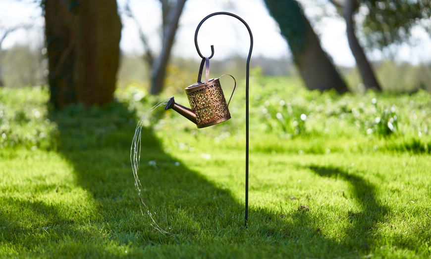 Image 9: Solar-Powered Illuminated Metal Watering Can Ornament