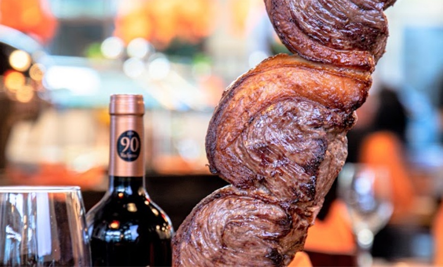 Image 1: All-You-Can-Eat Rodizio Dinner with Wine for 2 or 4 at Rio de Brazil Steakhouse Up to 28% Off