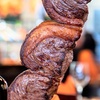 Image 1: All-You-Can-Eat Rodizio Dinner with Wine for 2 or 4 at Rio de Brazil Steakhouse Up to 28% Off