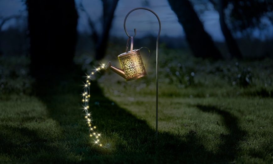 Image 1: Solar-Powered Illuminated Metal Watering Can Ornament