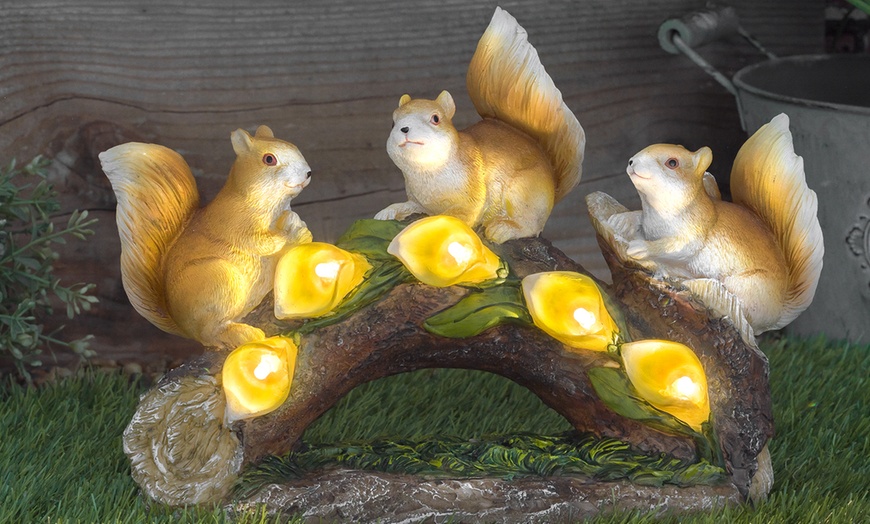 Image 1: One or Two Solar-Powered LED Illuminated Squirrels on Log Decorations