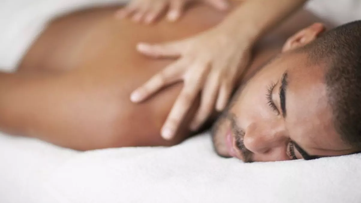 One 60-Minute Swedish or Hot Stone Massage at NatCan Integrative Medical + Wellness Centre (Up to 34% Off) - Primary Image
