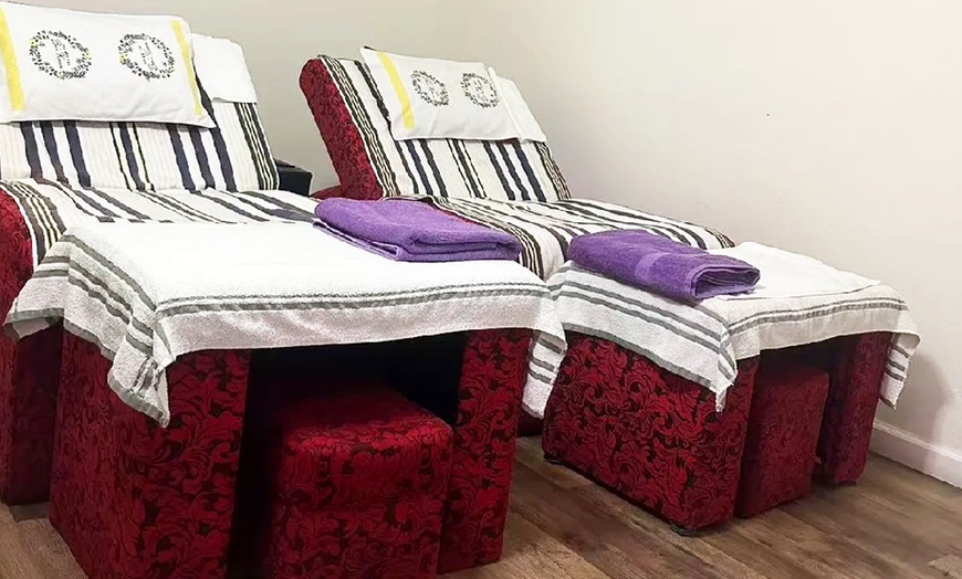 Image 1: Relax with 60-Minute Deluxe Body or Custom Combo Massage with Hot Stone & Optional Massage Oil (Up to 61% Off)