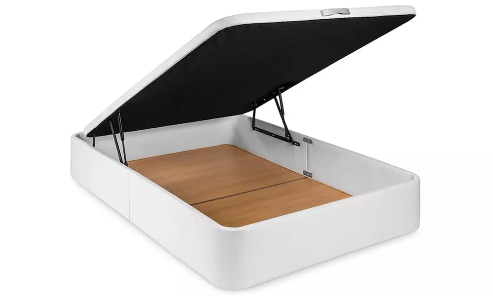 Canapé tapizado en polipiel de color blanco, con colchón y almohada