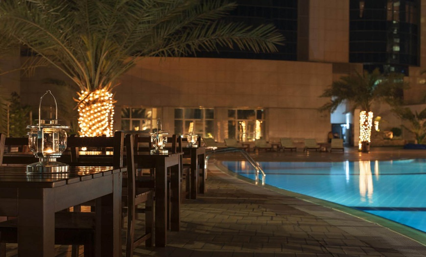 Image 4: Pool and drinks at Le Royal Meridien