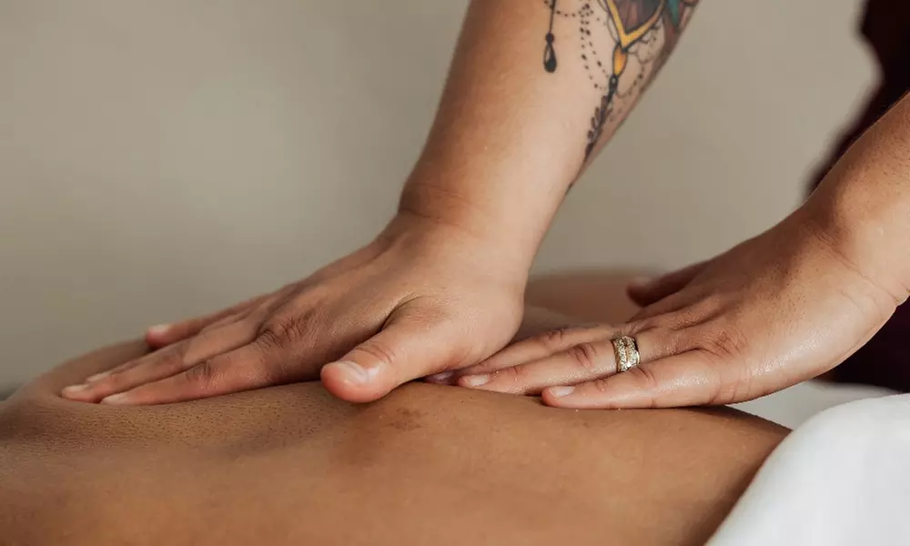 Unwind with a 50-minute Therapeutic Massage with Hot Stone or Cupping