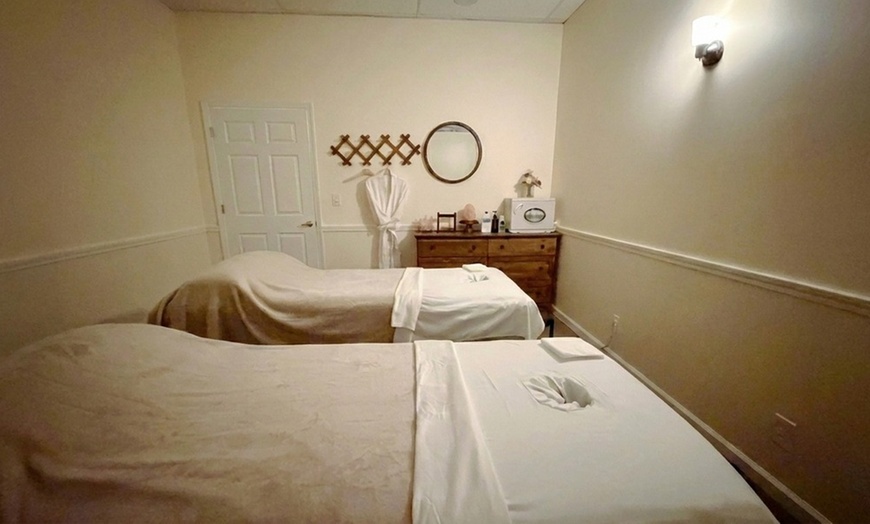 Image 2: Couples massage with hot stones and warm towel treatment