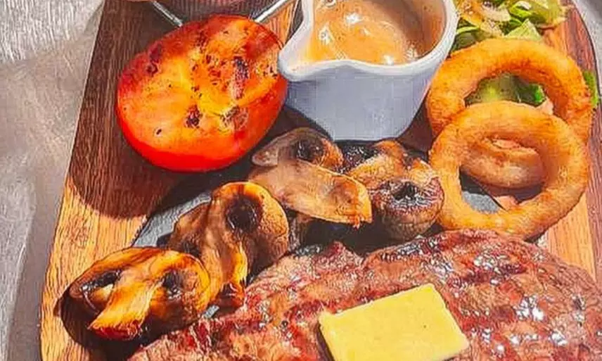 Savor Delicious Steak with Fries, Salad, Sauce and a Glass of Wine