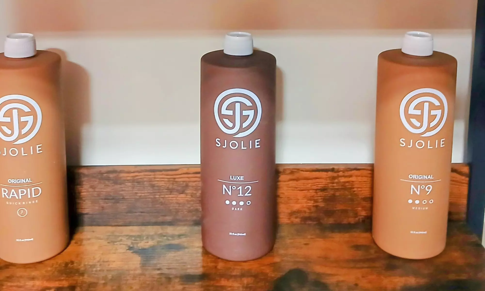 Enjoy a 1 or 3 Pack Organic Sjolie Spray Tan(s) or Brazilian Sugaring 