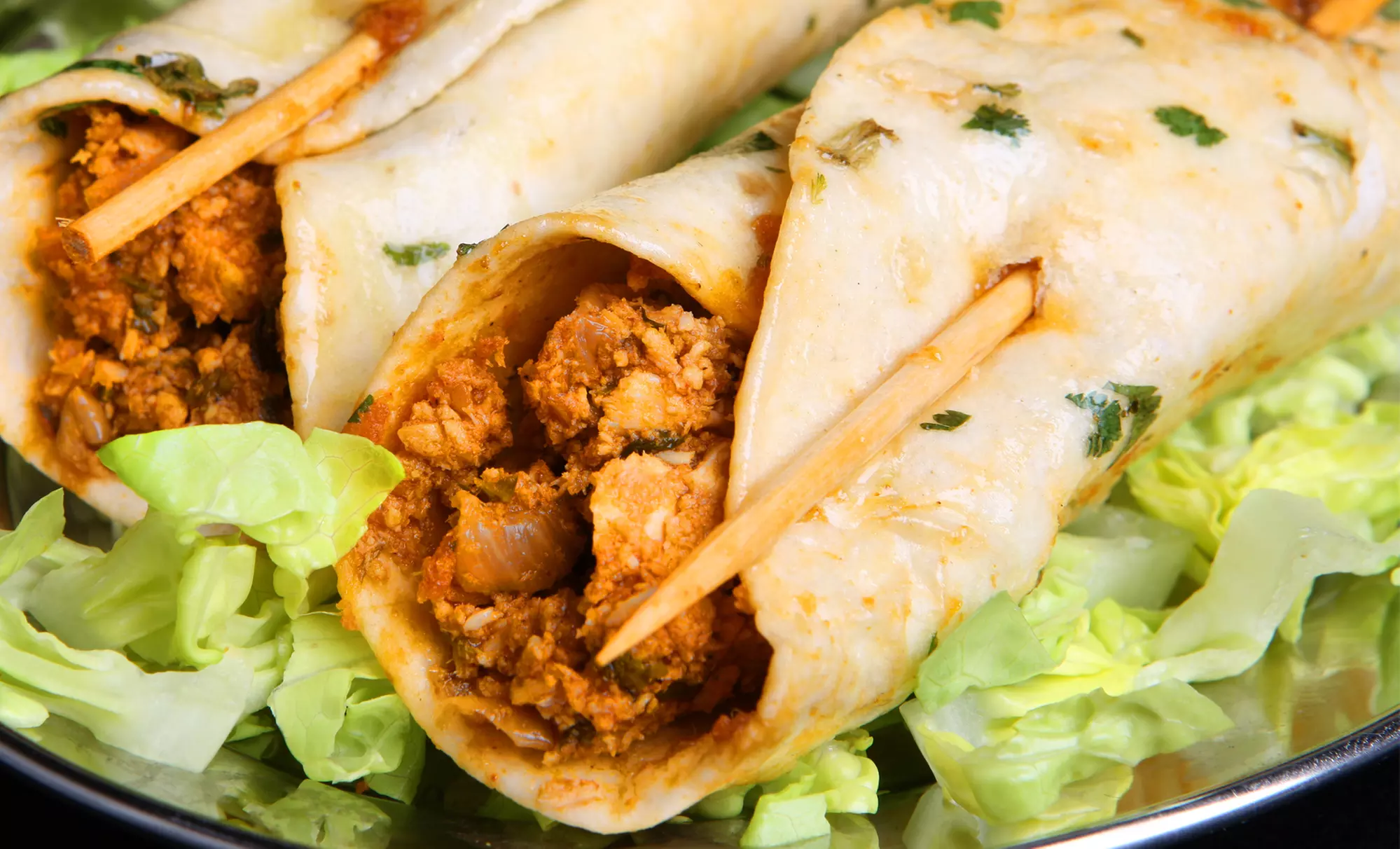 One or Two Groupons, Each Good for a Butter Chicken Wrap or Butter Chicken Poutine at Spice Magic (Half Off) - Primary Image