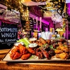 Image 1: Bottomless wings feast with a lively bar vibe