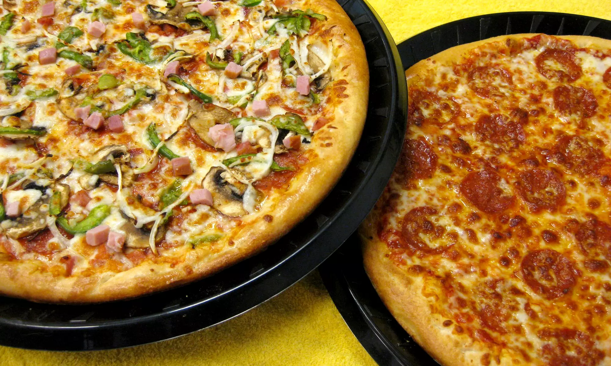 Two or Four Large Two-Topping Pizzas with Soda and Breadsticks at Riverside Pizza (Up to 58% Off) - Primary Image