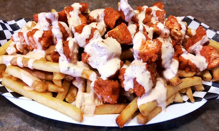 Family Meal with 25 Wings and 25 Tenders or Carryout at The Buffalo Spot (Up to 40% Off) - Primary Image