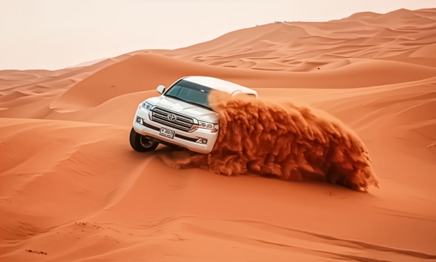 Image 1: Evening Desert Safari + BBQ, Sandboarding & Camel Ride For Up to 6