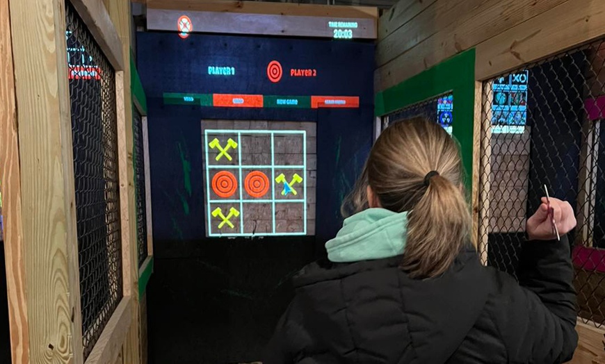 Image 1: One Hour Glow Dark Axe Throwing for Up to Four People in 1 or 2 Lanes