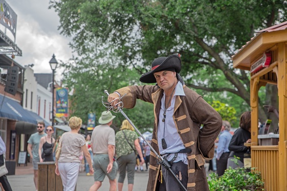 A lifelike wax figure of a pirate in a themed exhibit at the Savannah Pirates and Treasure Museum.