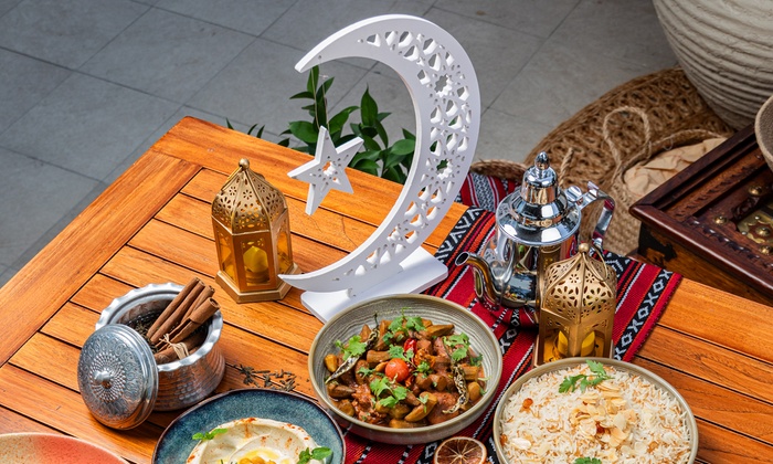 A lavish spread of Middle Eastern dishes, including grilled meats and traditional mezze, ready for an Eid celebration