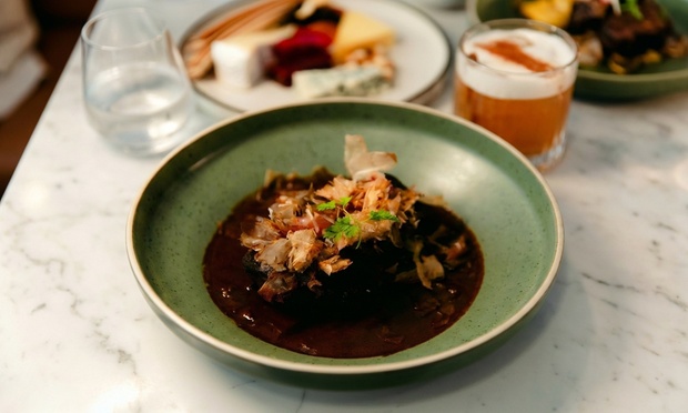 Table set with plates, cutlery, and wine glasses, ready for a modern Australian meal.