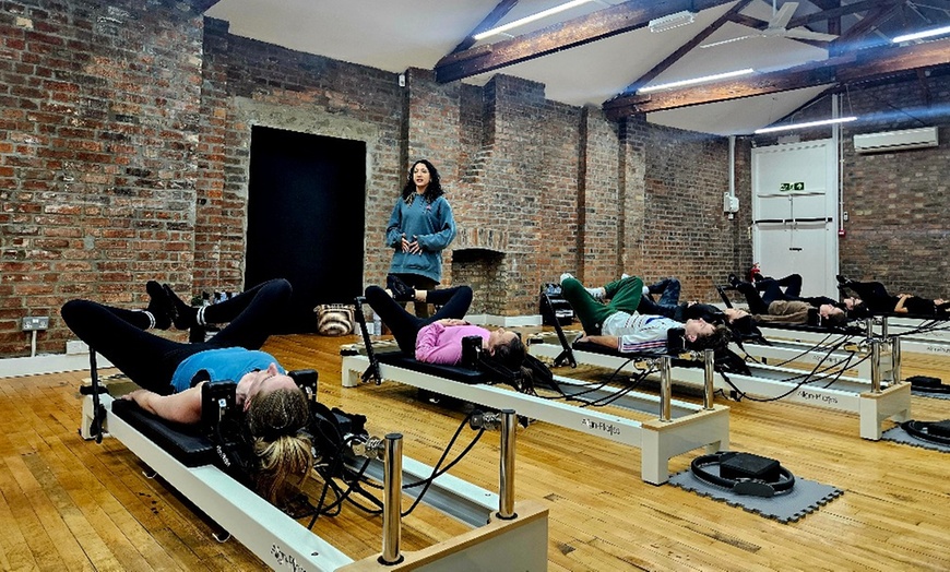 Image 1: Elevate Your Wellness Journey: 5, 10, or 20 Reformer Pilates Classes at Flowing Body Pilates (Up to 63% Off)