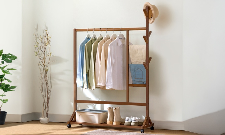 Image 1: Brown Bamboo Garment Rack with Wheels and  Bottom Shelf
