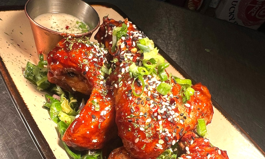 Image 2: Bottomless wings feast with a lively bar vibe