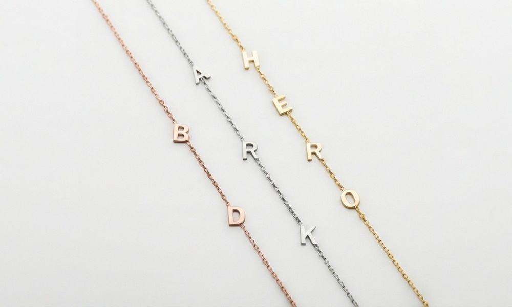 Design a unique 14K solid gold initial necklace with Becca Prado, featuring customizable options from 1 to 8 letters