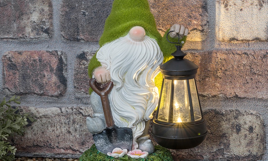 Image 1: One or Two Solar Lantern Flocked Garden Gnomes