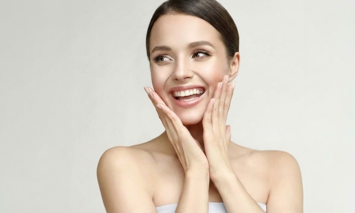 Close-up of a person receiving a facial treatment, showcasing clean, glowing skin with a gentle, professional touch.